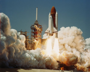 Challenger lifts off on its first flight, during a time when space flight was being seen as routine as airline travel.