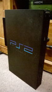 My PS2. Dusty, beaten up, and missing the Playstation emblem on the disc tray, but still working.