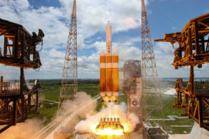 The launch of NROL-37. Note the scorched foam insulation on the tankage, and the orange glow in the flame, caused by carbon burning from the nozzles of the engines.